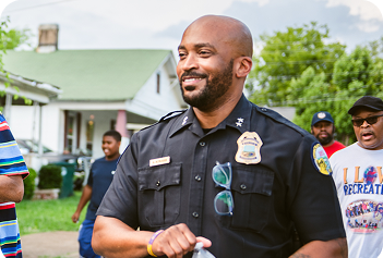 A Chattanooga Police Officer walking down a local neighborhood.