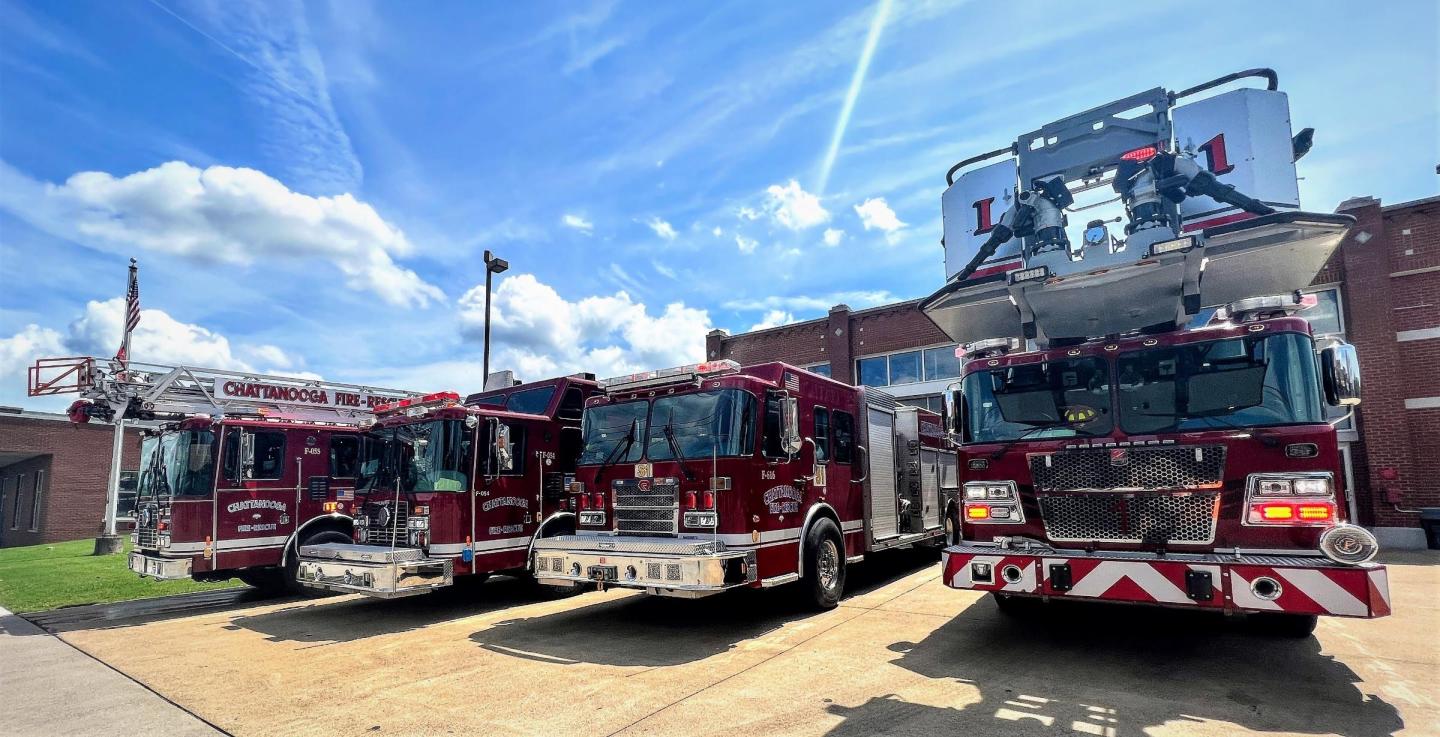 Fire station 1 with three fire trucks parked in front of the building.