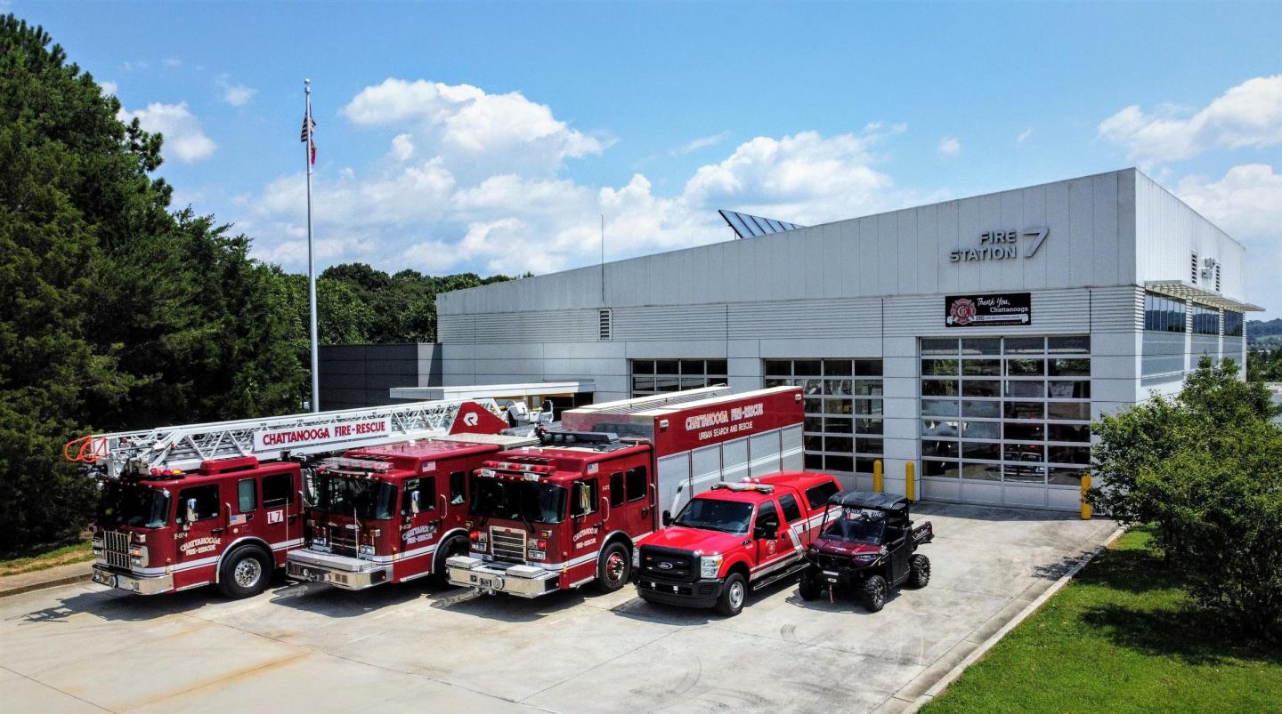 Chattanooga Fire Station 7 with fire trucks and a rescue vehicle parked in front, featuring a modern building design.