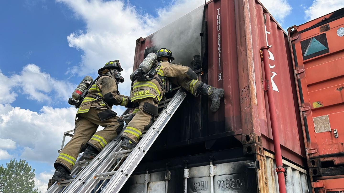 Fire fighters entering smoking container