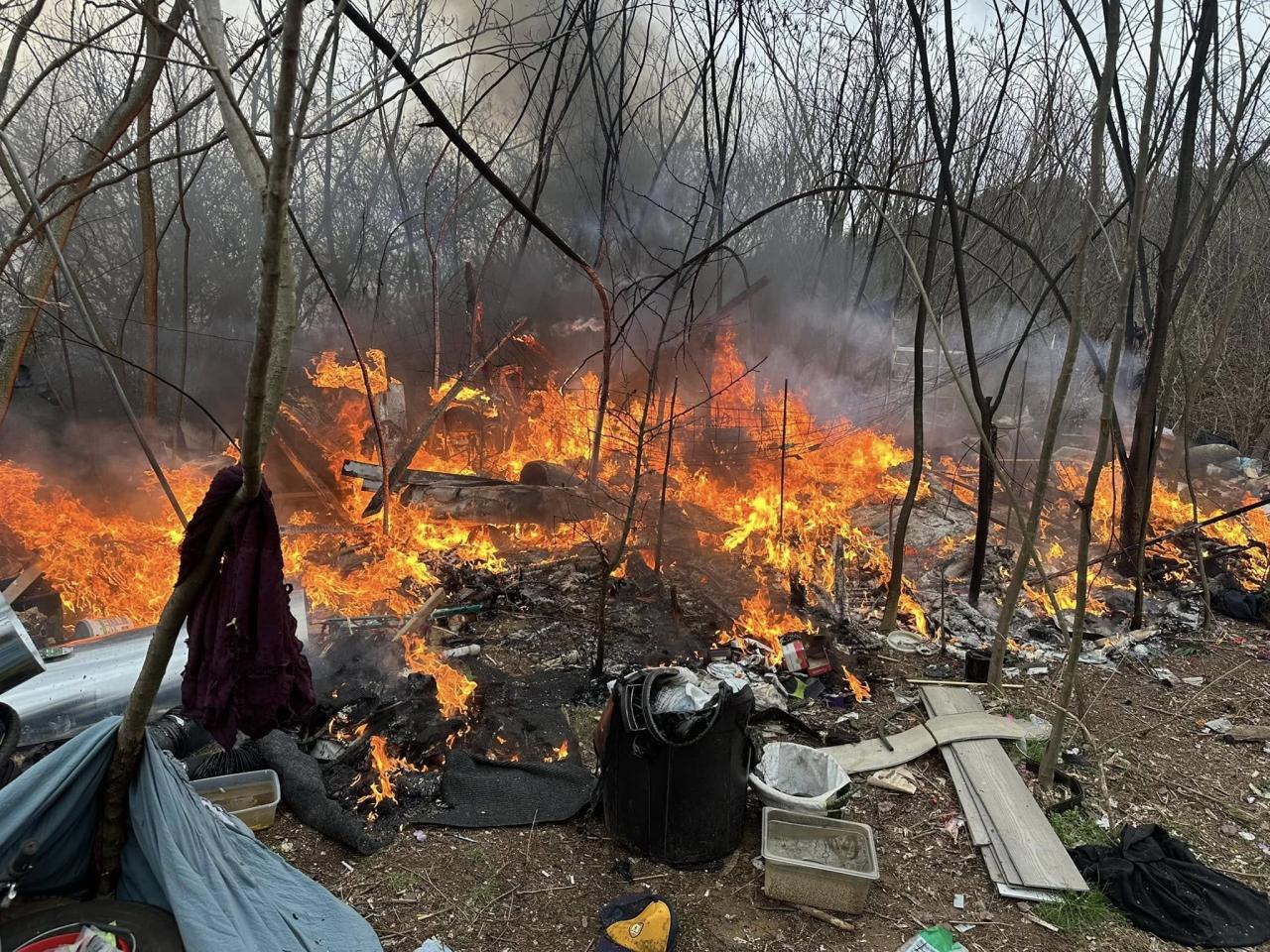 Firefighters tackle fire at homeless encampment