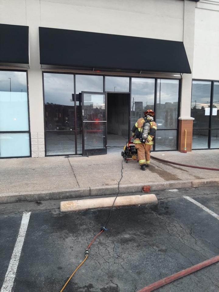 Firefighter walking out of the building where the smoke was seen