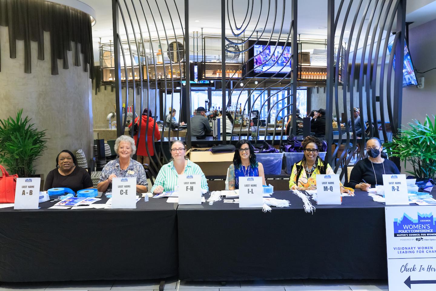 Registration table with six women