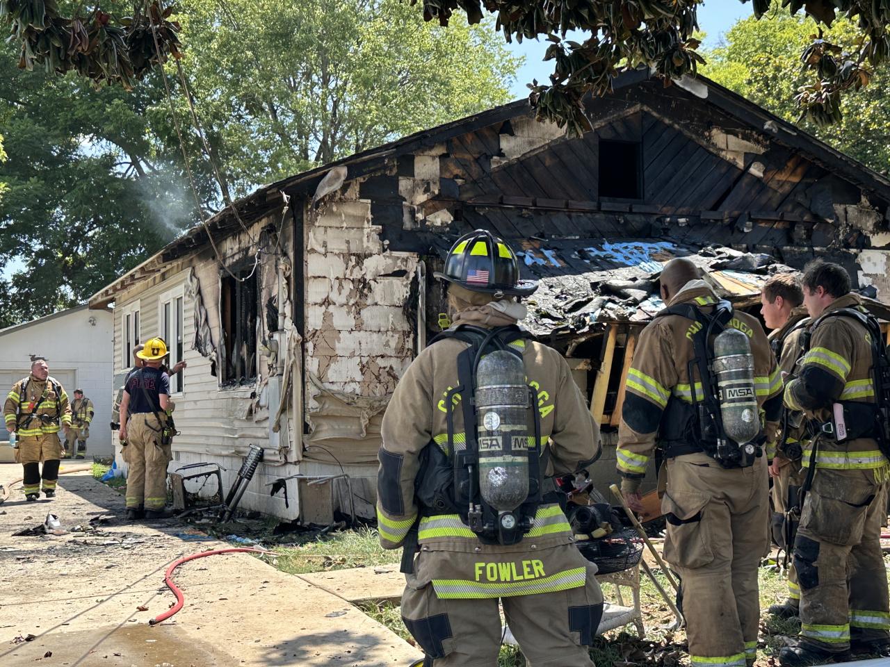 Fire damage and Firefighters assessing the damage