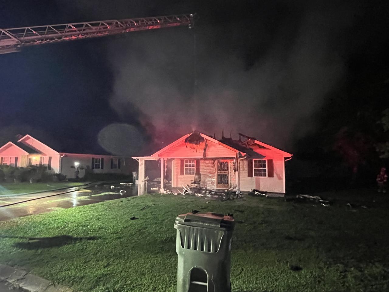 Front view of house with burned roof
