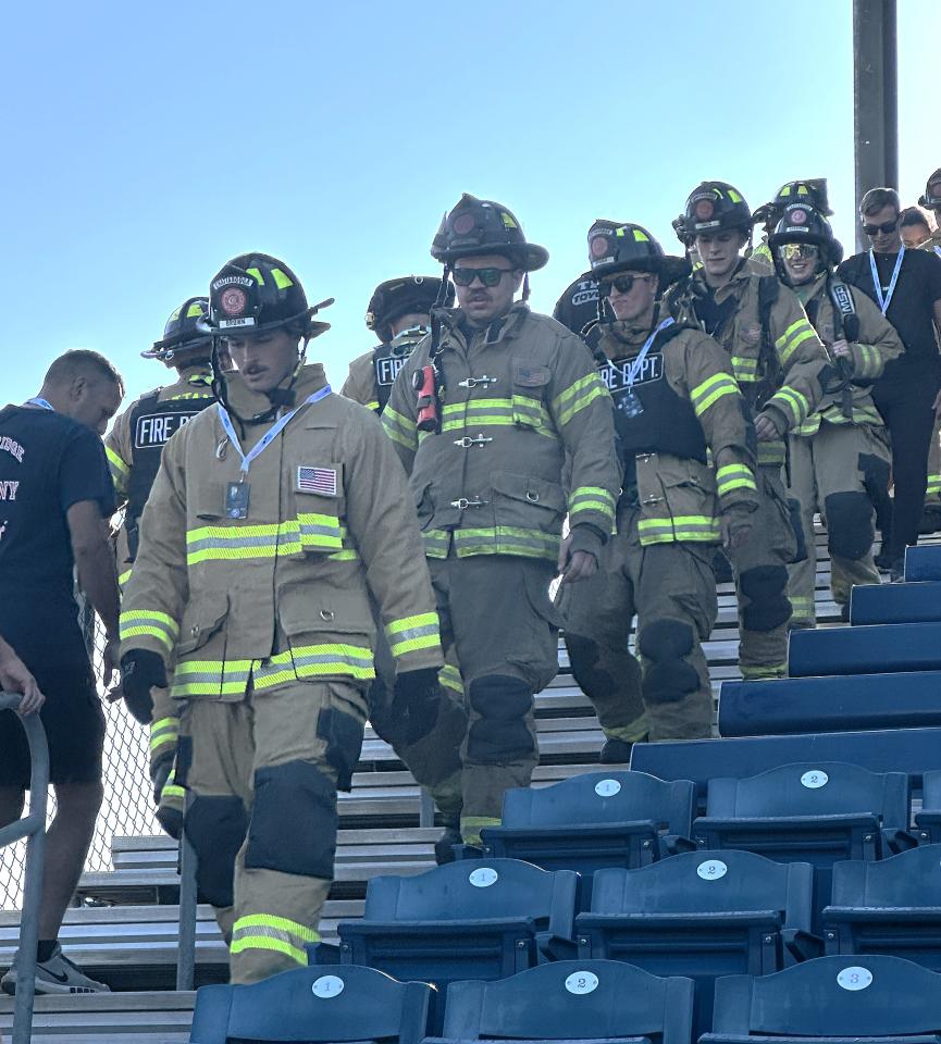 Firefighters in uniform walking down stairs