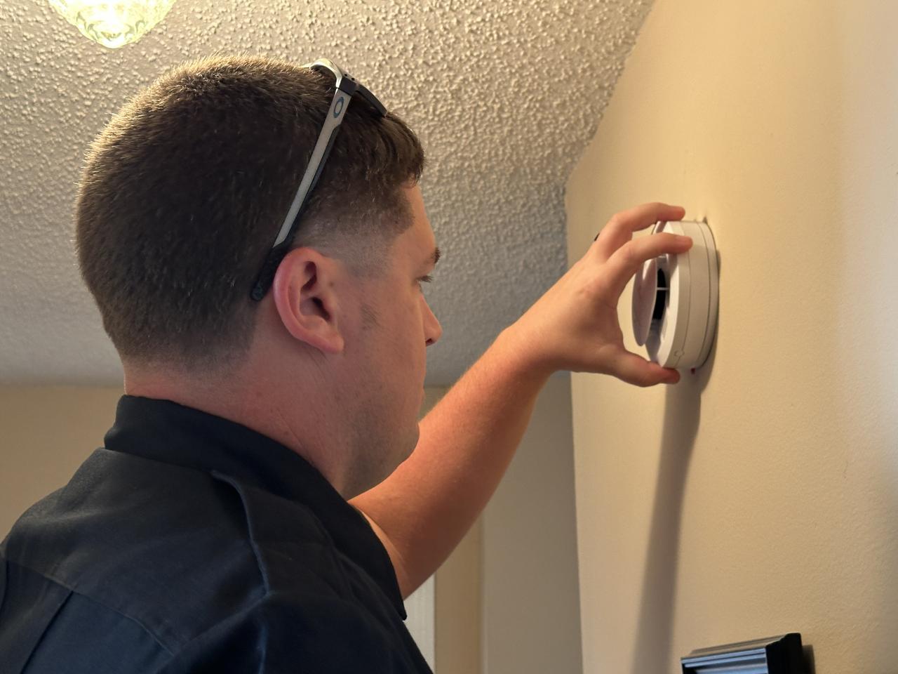 Firefighter installing a smoke alarm