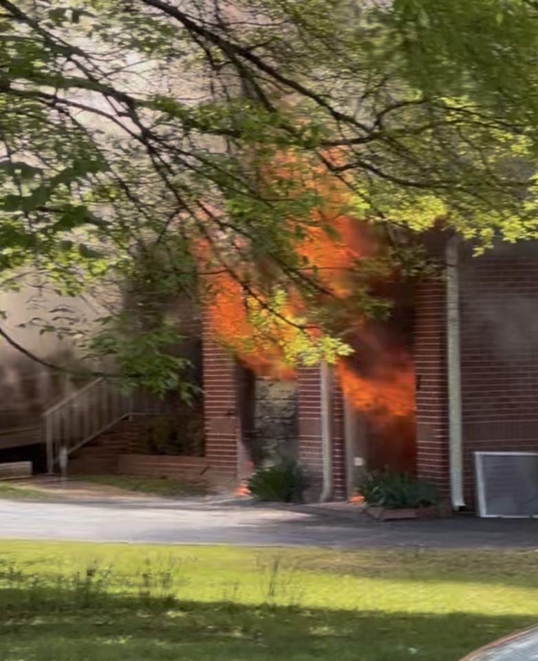 Fire coming out of the front of a brown house