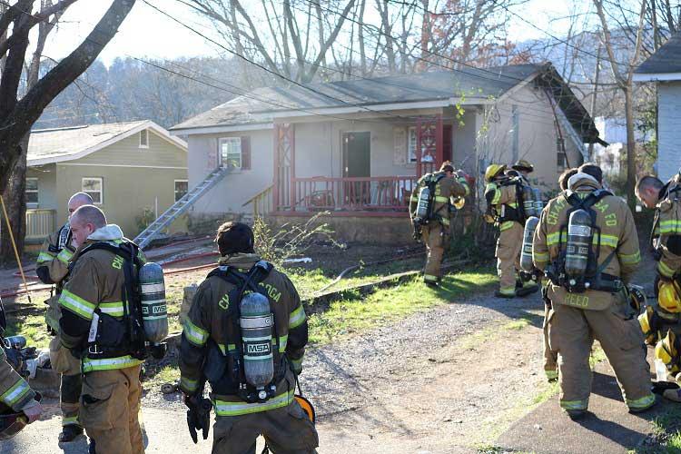 Firefighters Carry Woman from Burning Home