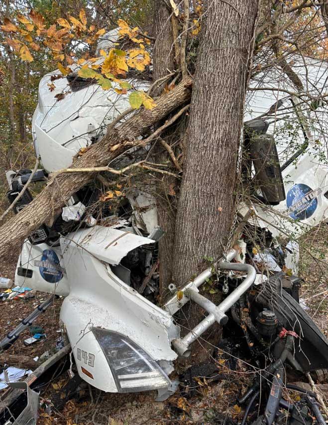 Firefighters extricate semi driver after truck slams into tree