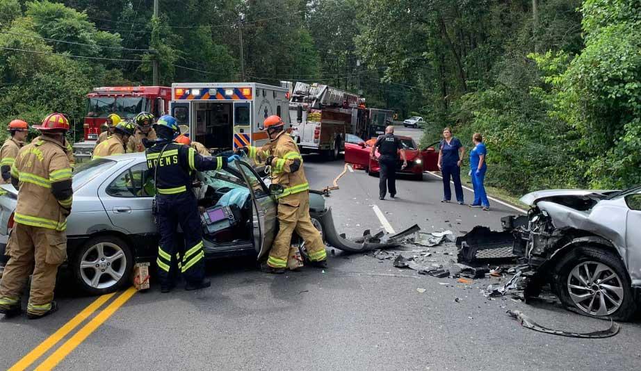 Firefighters work extrication following head-on collision
