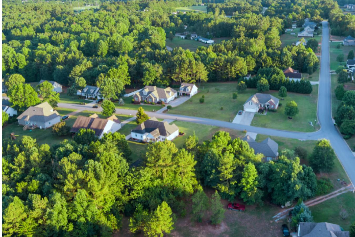 Aerial view of neighborhood homes with a lot of trees