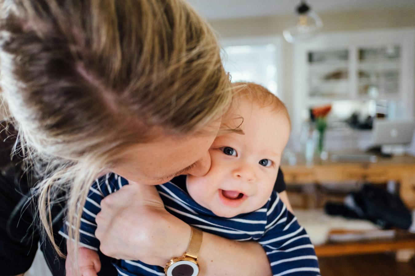 Female holding smiling infant