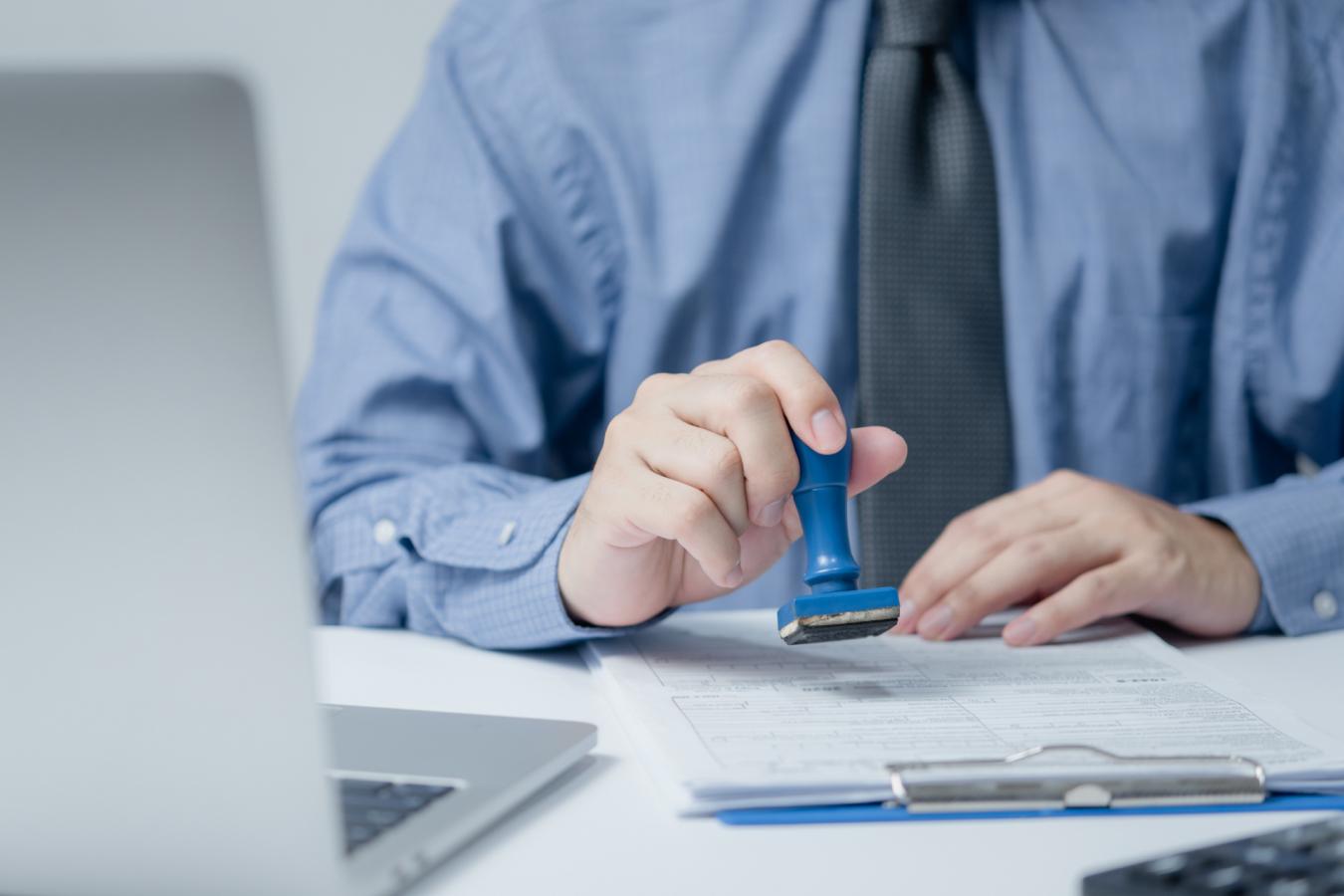 Man stamping documents