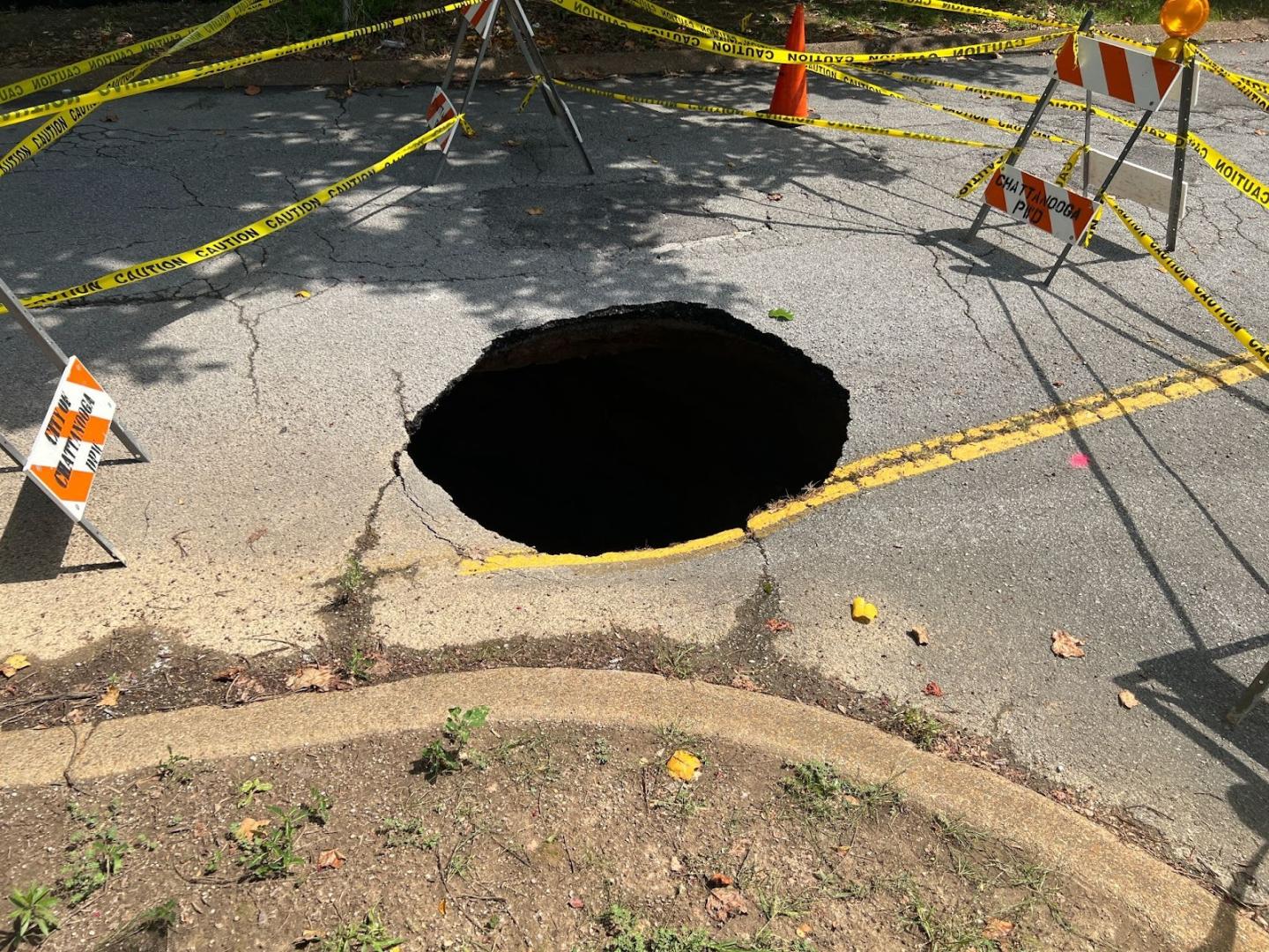 Hole in pavement in the middle of road