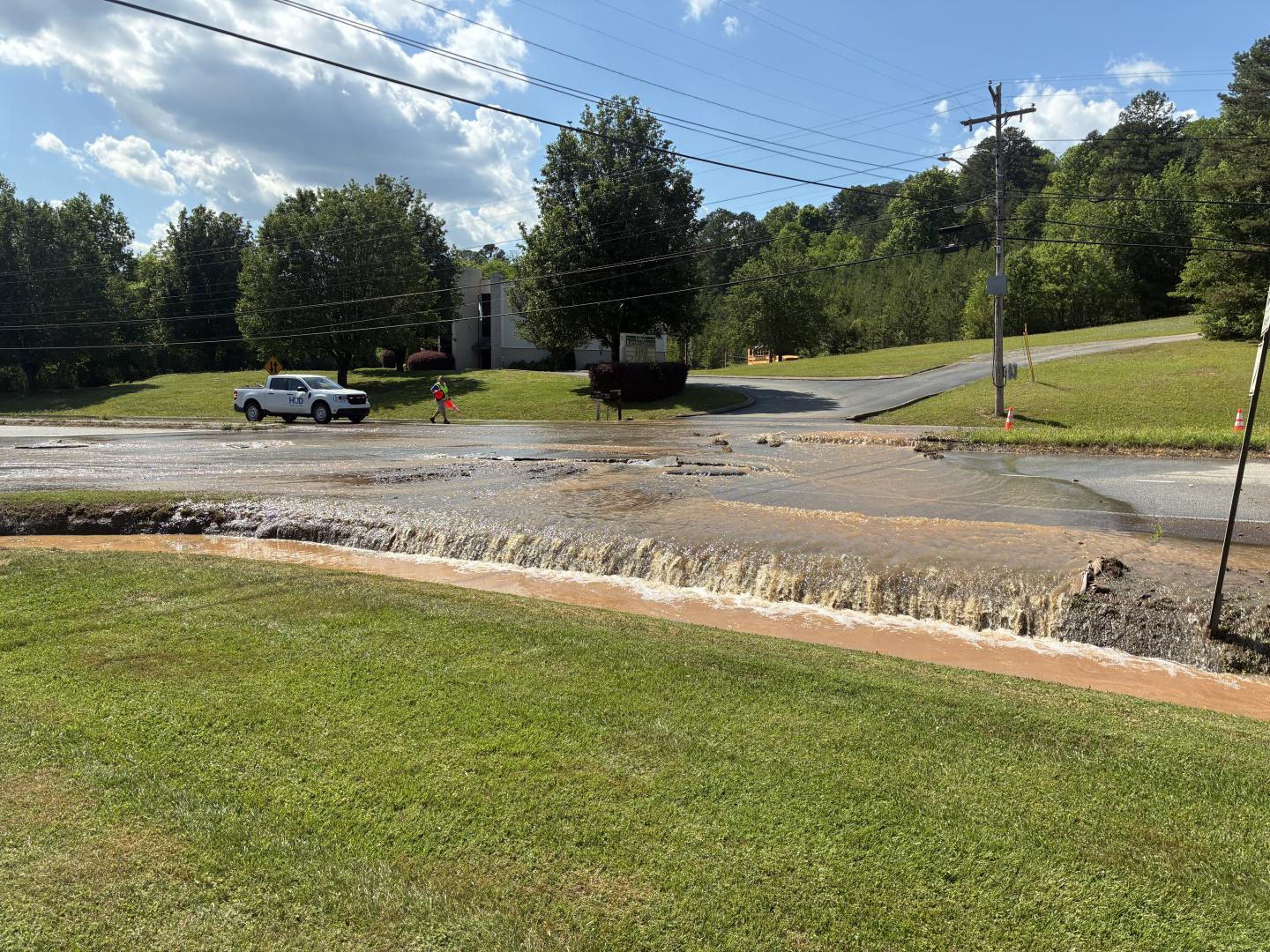 Large amounts of water flowing over side of the road