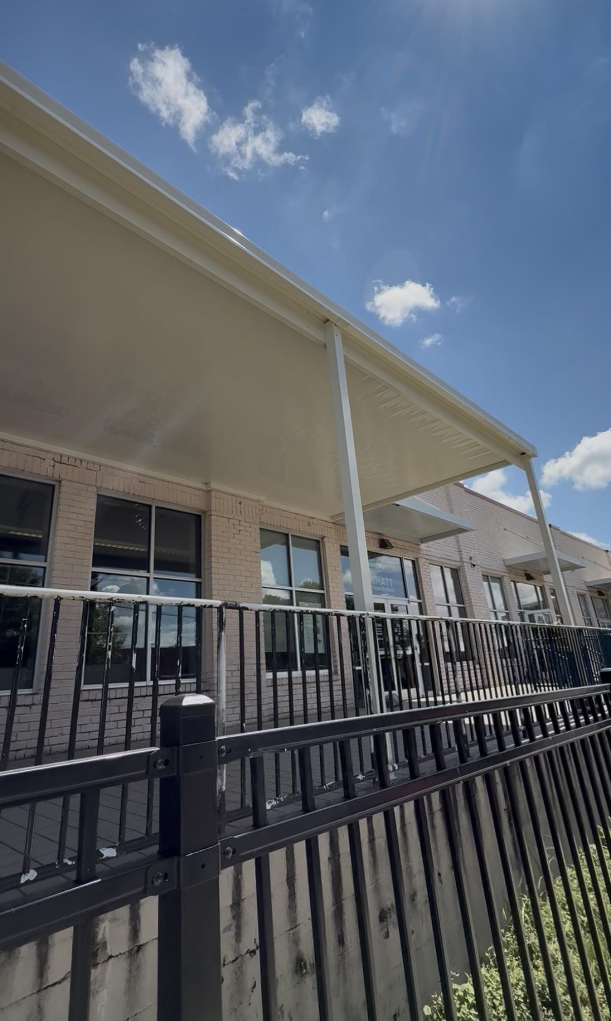 Front view of 4 windows with the awning above it. 